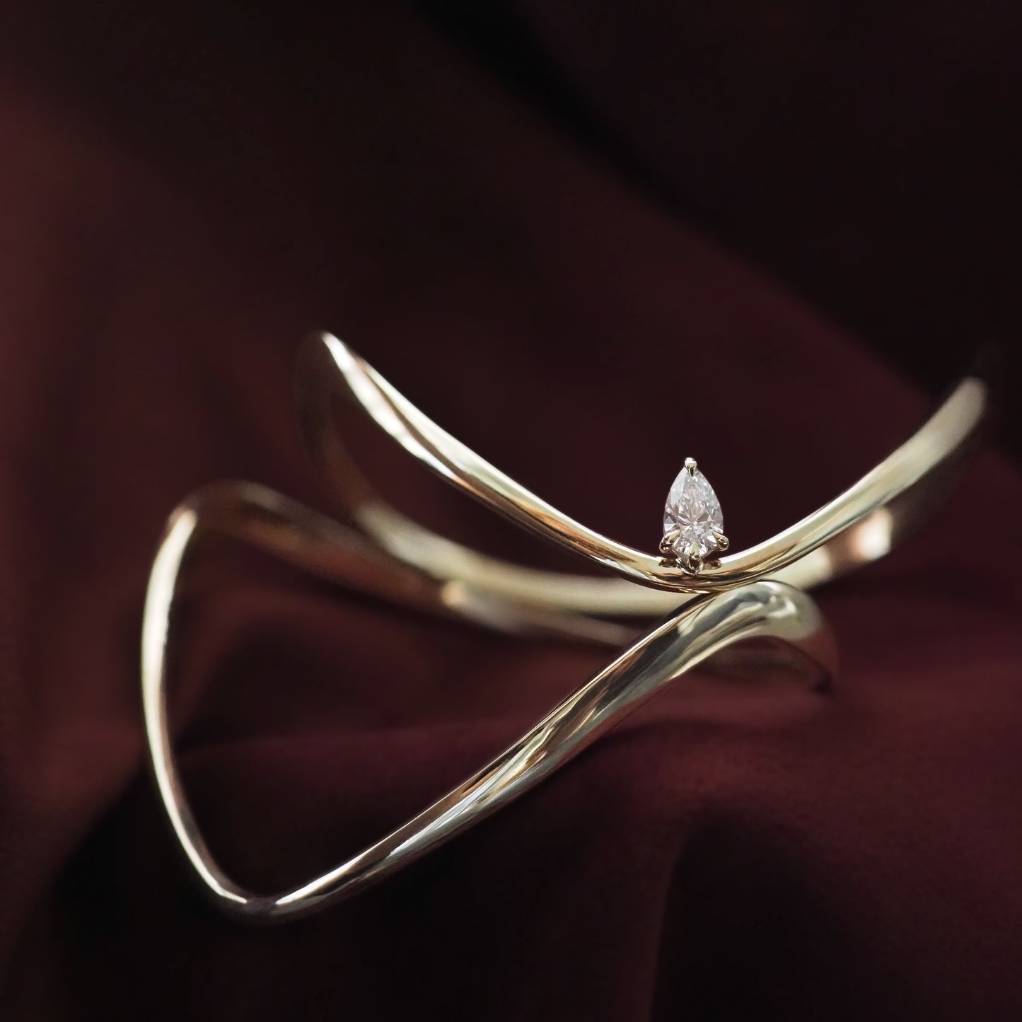 Gold bracelet with a diamond on a dark background