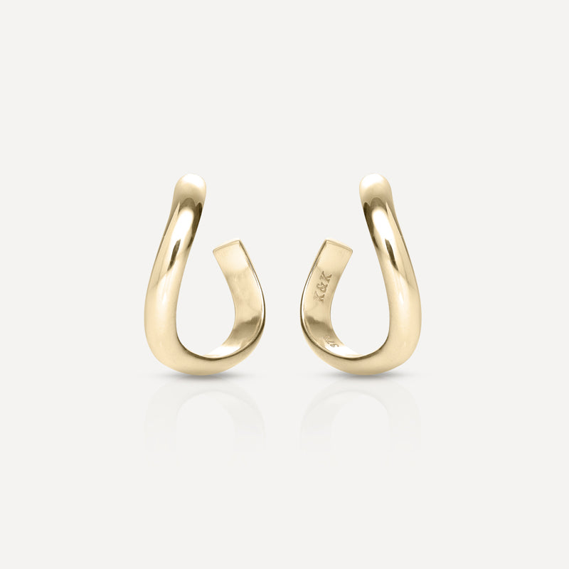 Elegant gold hoop earrings with a sleek, twisted design, displayed on a light background. Perfect for luxury fashion and jewellery enthusiasts.