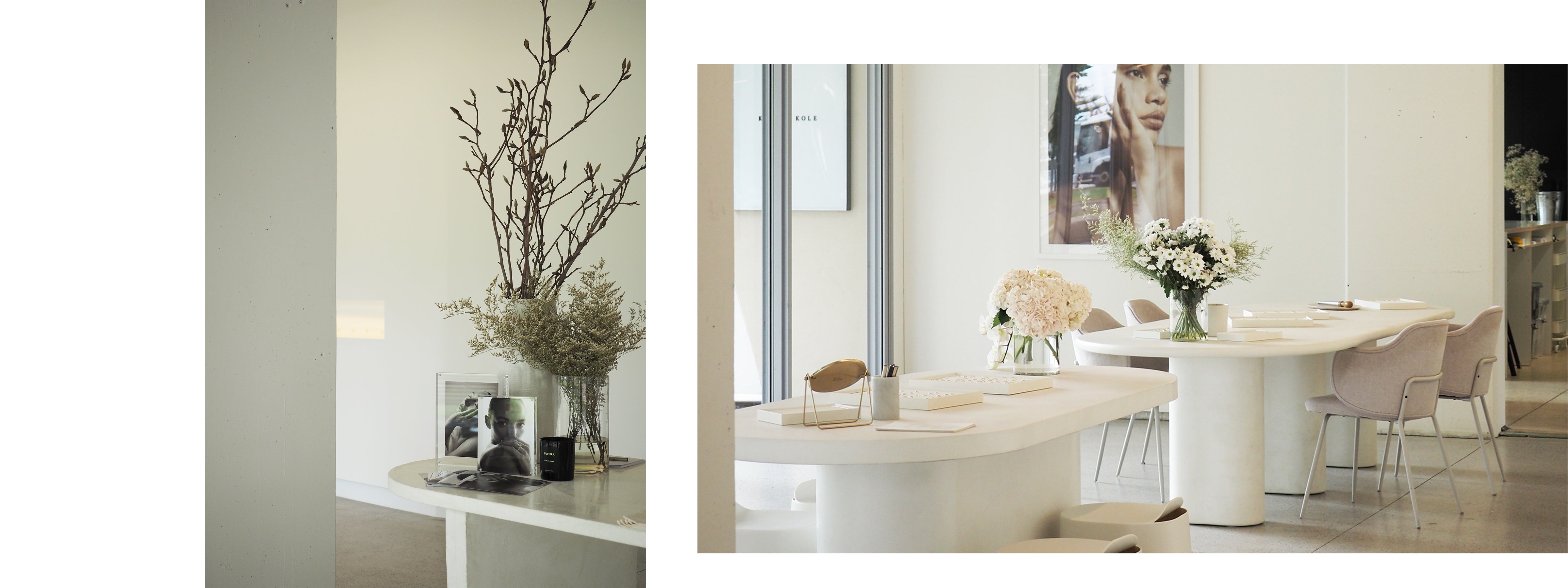 Elegant jewellery showroom with modern white tables, fresh floral arrangements, and artistic wall decor, exuding luxury and sophistication.