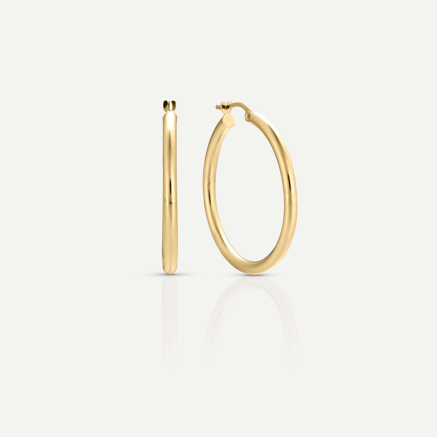 Elegant gold hoop earrings on a plain white background, showcasing their sleek and polished design.