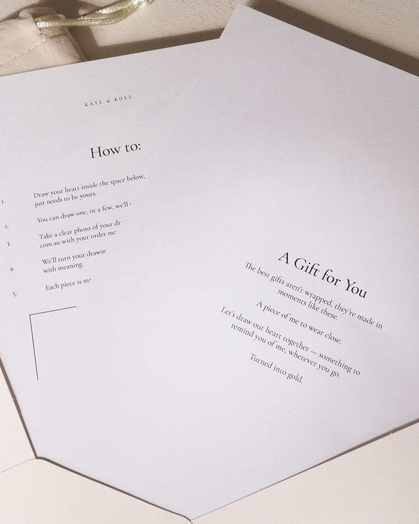 Greeting card with text and a small envelope on a light wooden surface