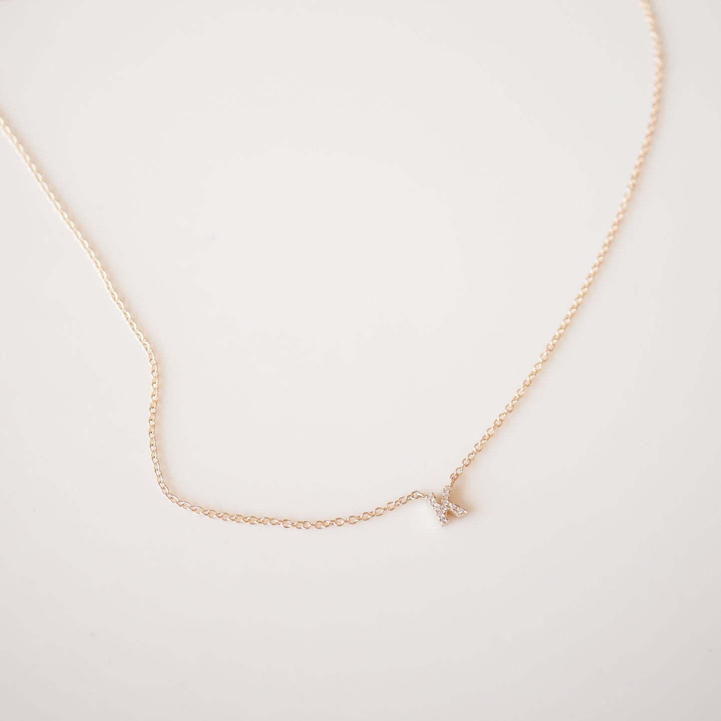 Gold diamond letter necklace on a cable chain