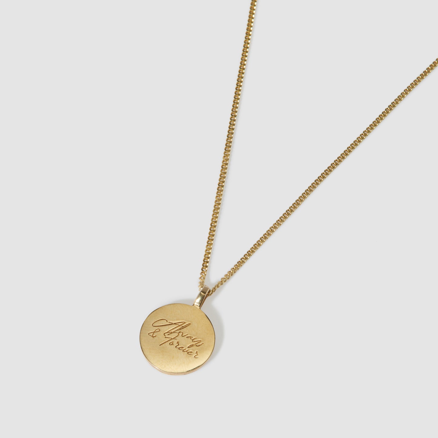 Gold pendant necklace with "Always & forever" engraving on a delicate chain. Ideal luxury jewellery piece for timeless elegance.