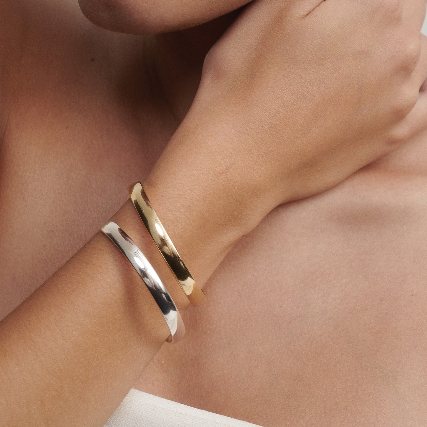 [text overlay: Our Extra Small (60mm) Cuff stacked in Silver and 9ct Yellow Gold]