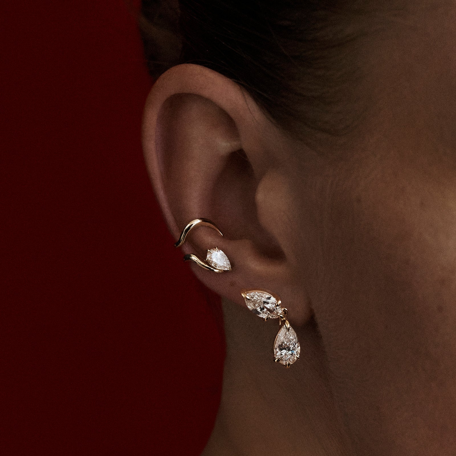 Close-up of an ear wearing gold earrings with a dark background

[text overlay: Model wears Piece 10—The The Étreinte Cuff above Piece 7—The Toi et Moi Earring]