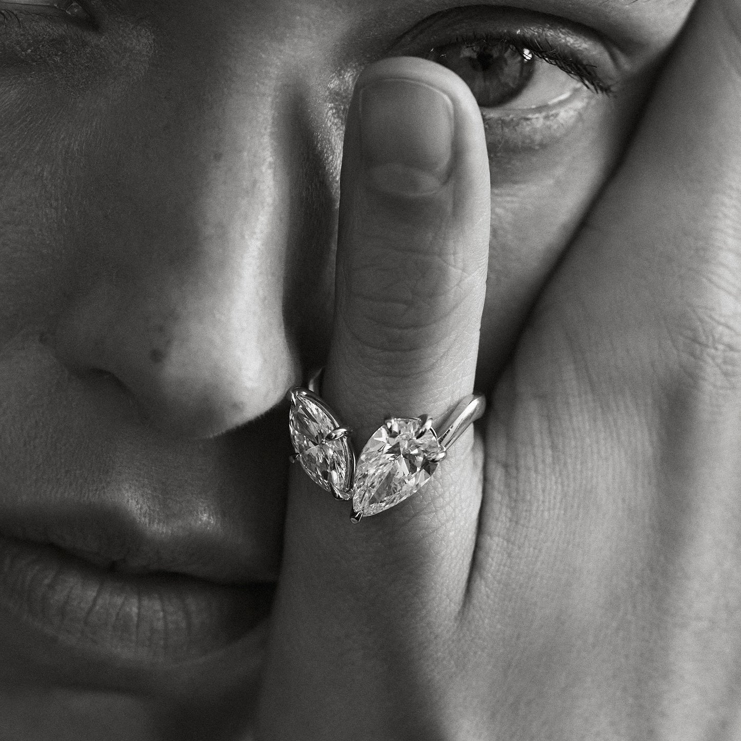 Close-up of a person wearing a diamond ring with a blurred background