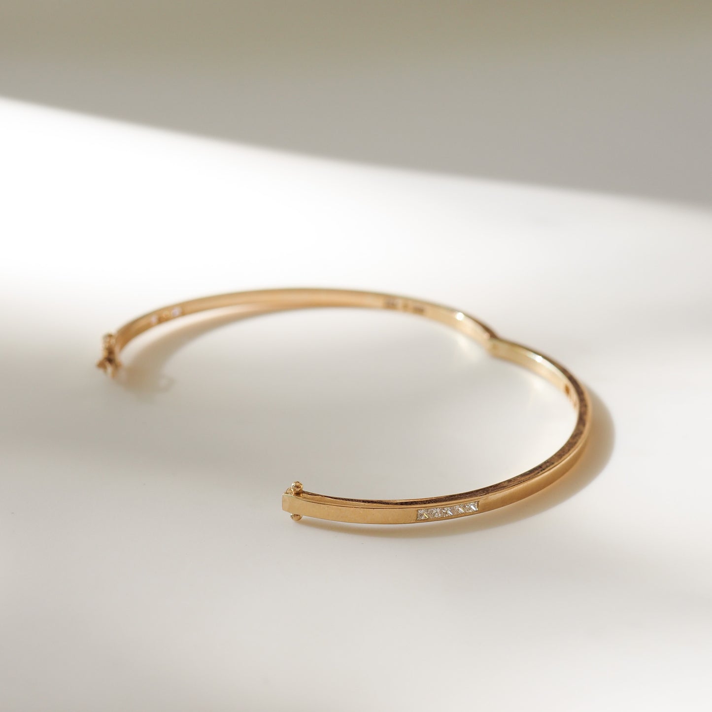 Gold bracelet on a light background