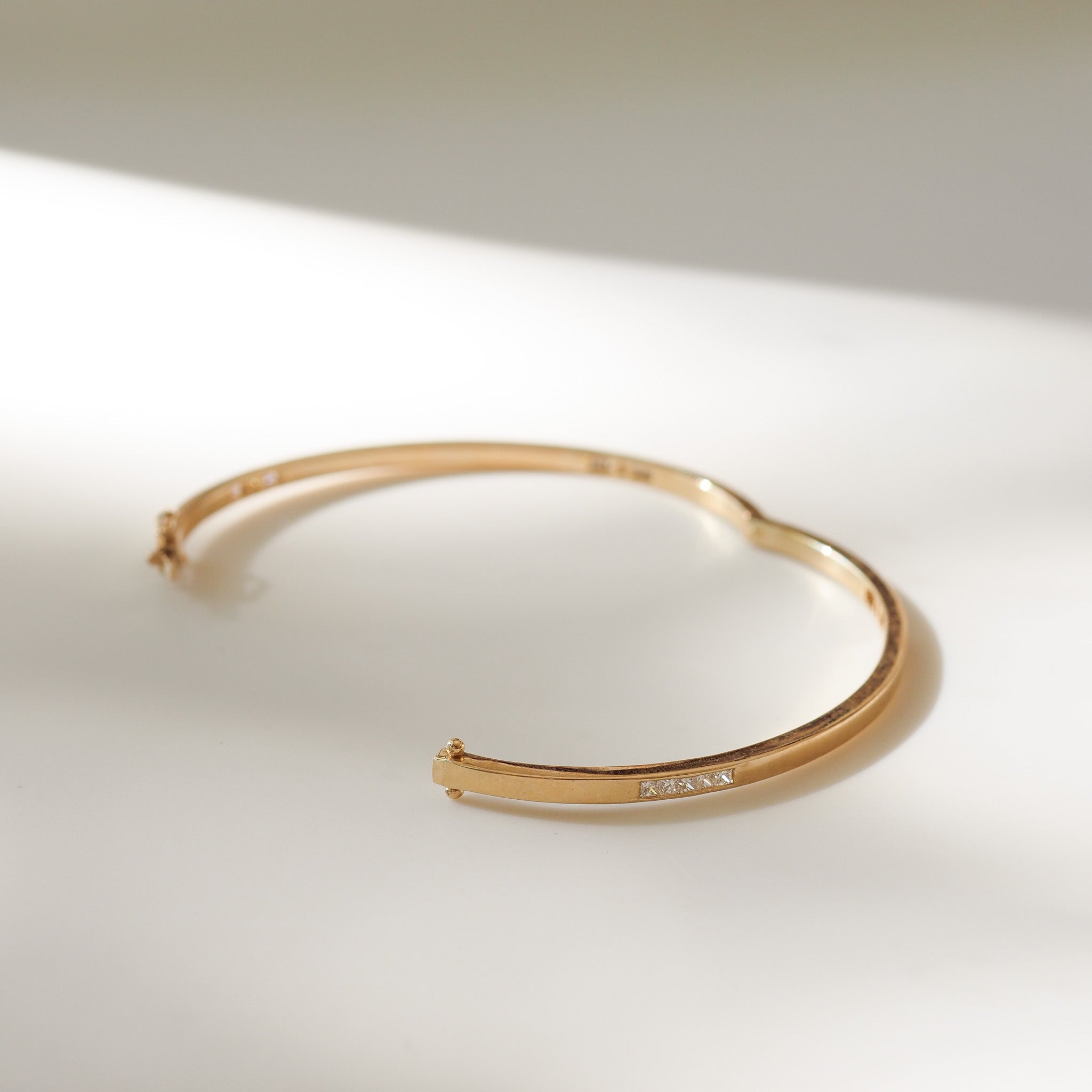 Gold bracelet on a light background