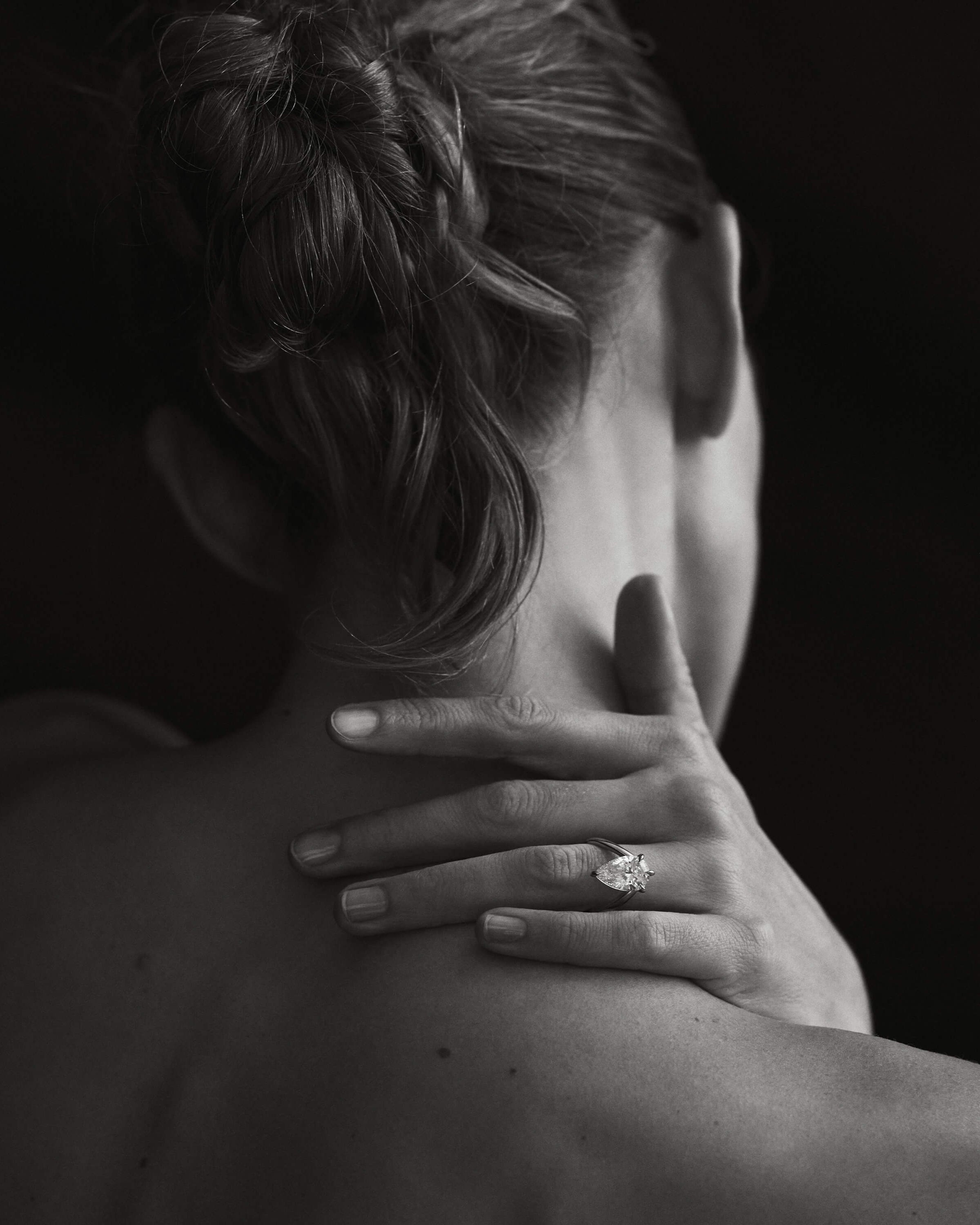 Kate & Kole diamond ring on hand, worn on the shoulder.