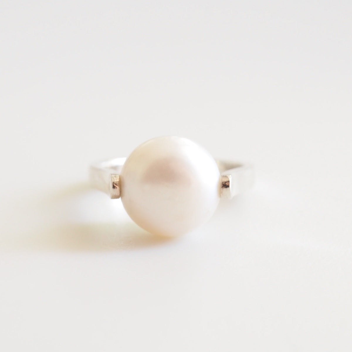 Pearl ring on a light background