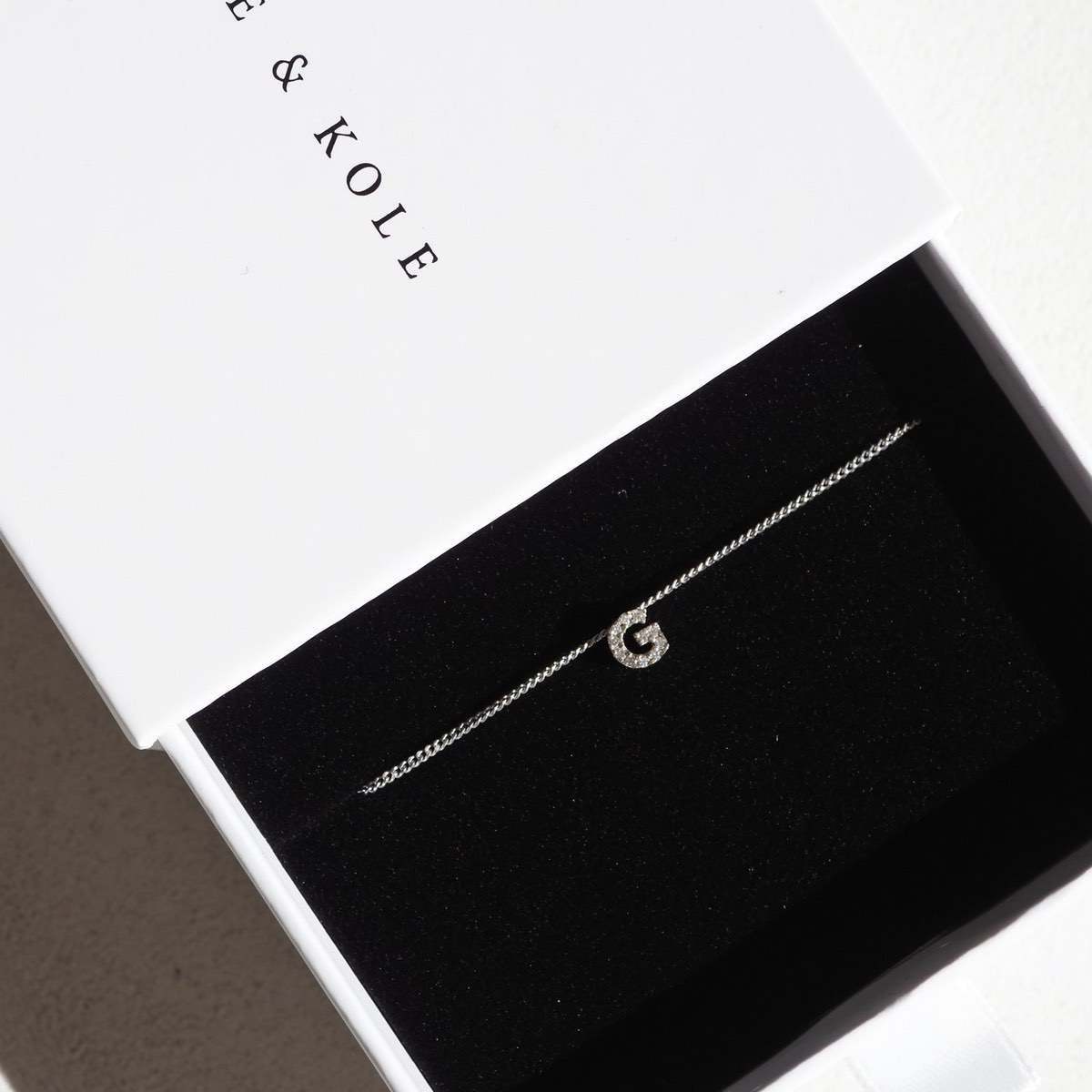 Diamond Letter Charm necklace sitting perfectly in a white Kate and Kole jewellery box

[text overlay: Sliding Diamond Letter Archive Charm on a 1.1mm Diamond Curb Chain (chain not included)]
