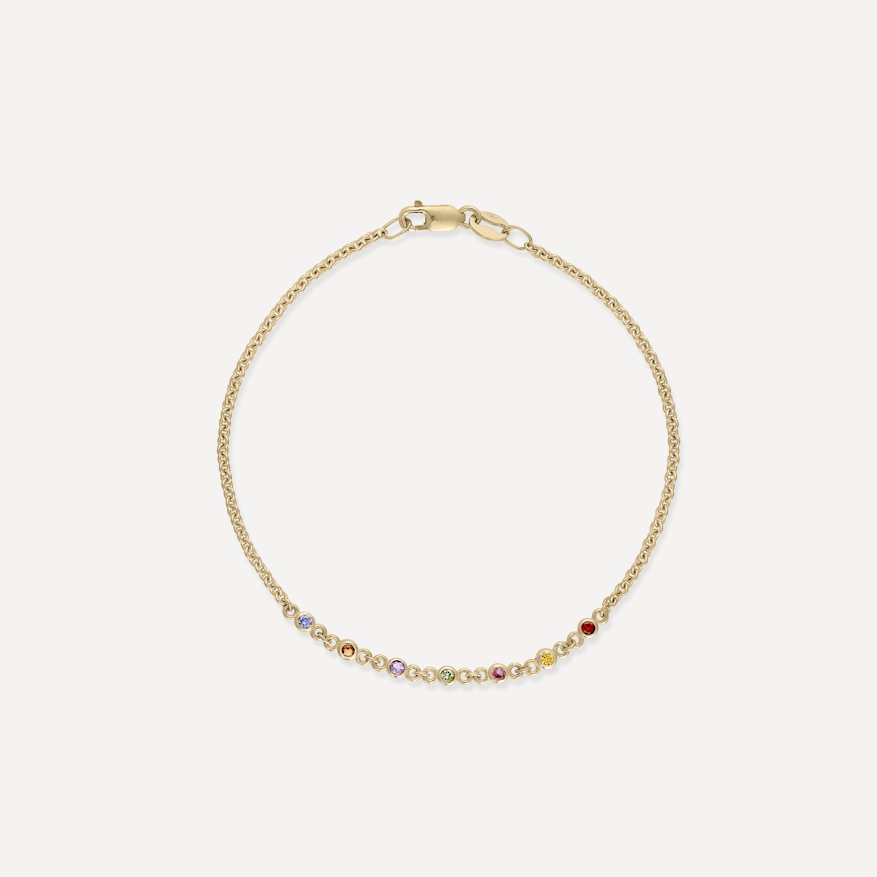 Elegant gold bracelet with a delicate chain and small multicoloured gemstones. Ideal for luxury jewellery lovers.
