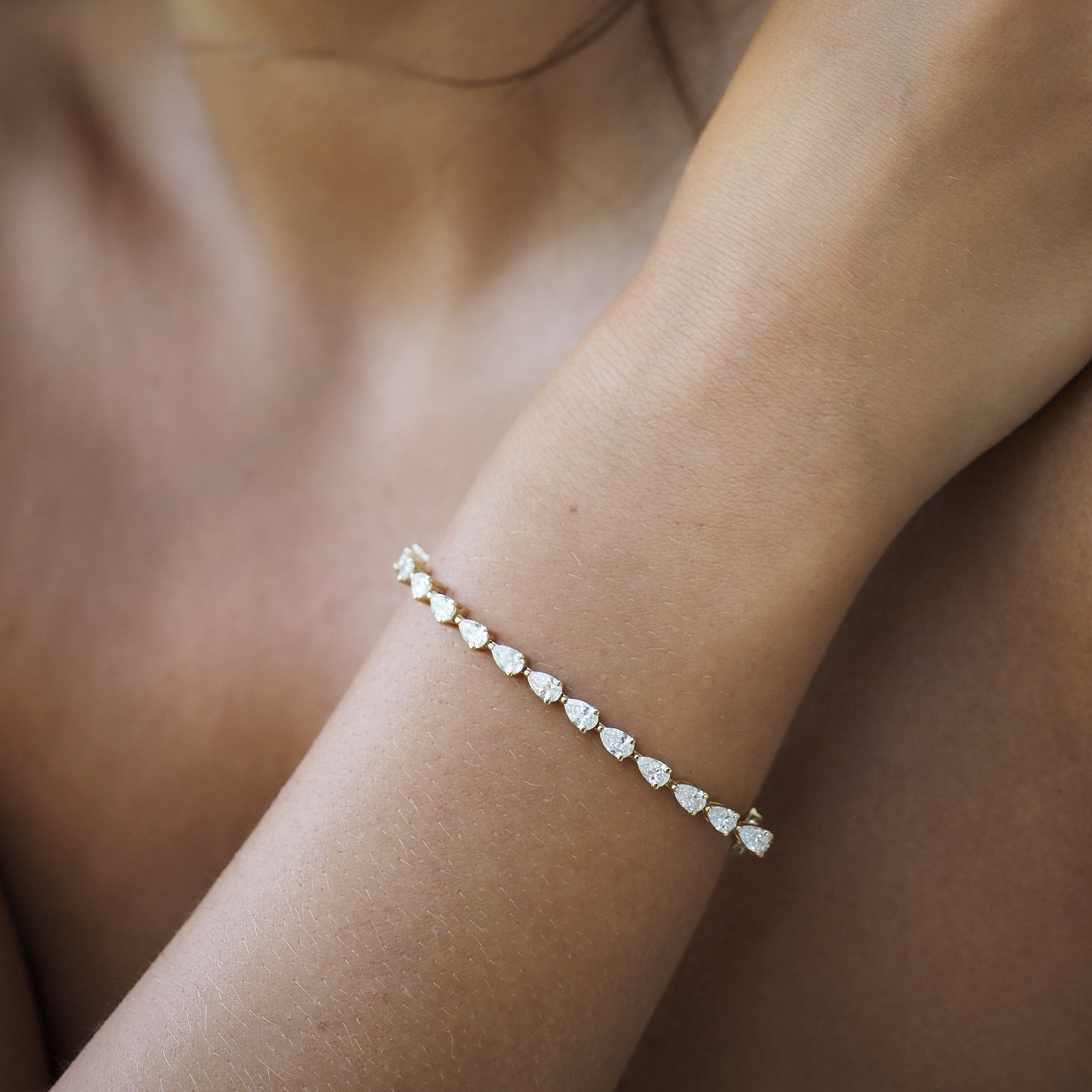 The Pear Diamond Tennis Bracelet effortlessly dazzles with up to 100 carefully set Lab-Grown Diamonds, promising endless sparkle.