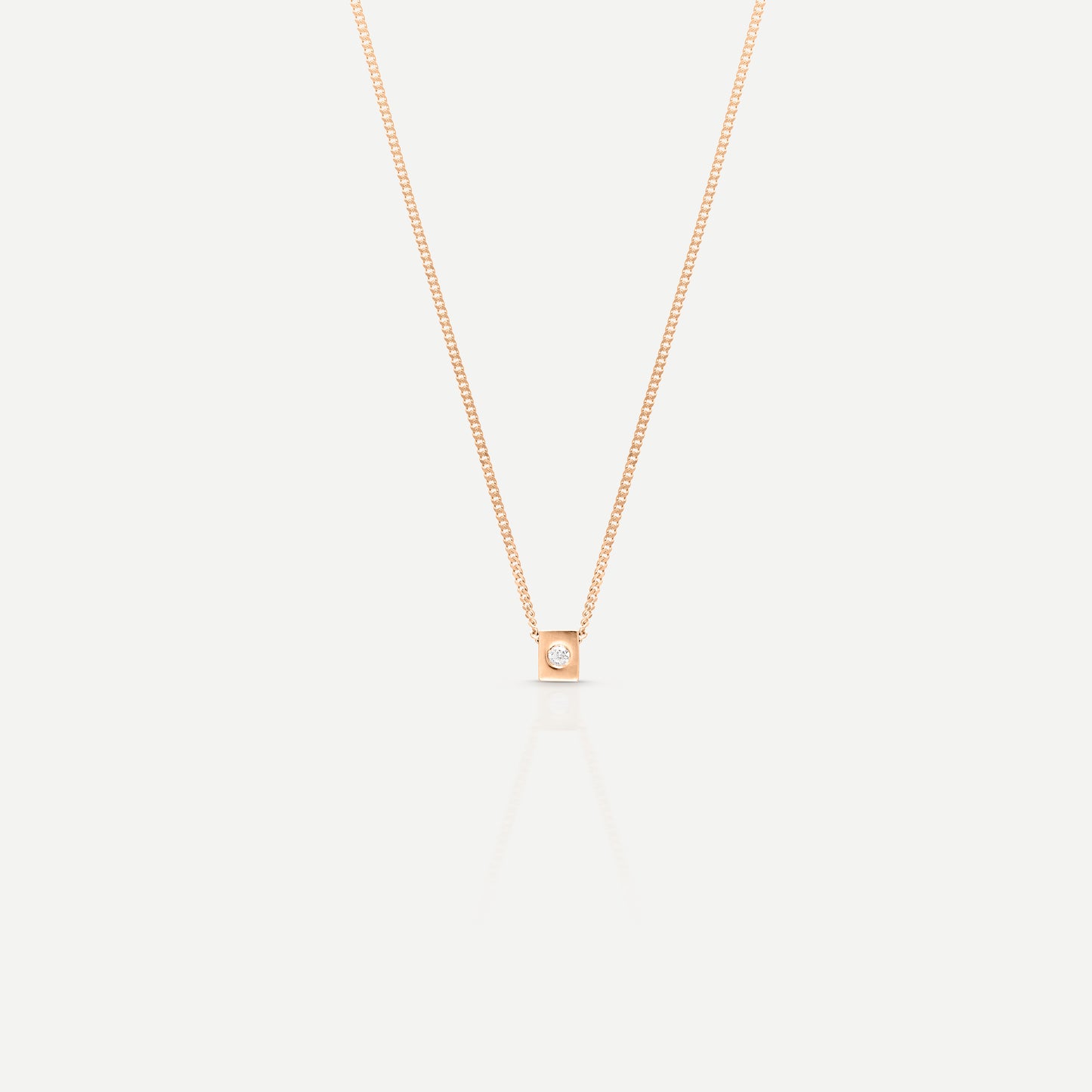 Elegant rose gold necklace with a single diamond pendant on a light background, showcasing minimalist luxury jewellery design. [text overlay: The Leader Archetype in Rose Gold] [text colour: #000000]

