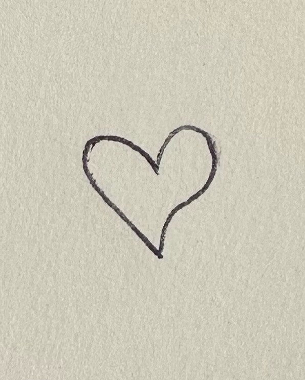 Simple hand-drawn heart sketch on textured cream paper, symbolising love and elegance; perfect for luxury jewellery concepts.