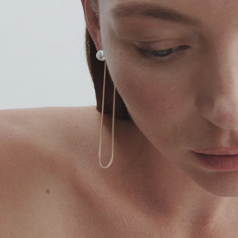 Model wears Natural Baroque Pearl Studs with Solid 9ct Yellow Gold Drops
[text overlay: Snake Chain Drops styled with our Pearl Studs]