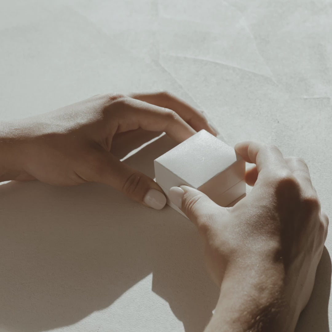 Our Isla trilogy ring features a cluster of three meticulously set stones, an emerald centre stone shouldered by two trillion stones