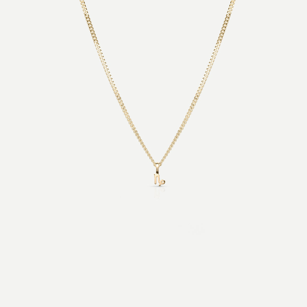 Solid gold and silver jewellery: A single Kate & Kole hand finished zodiac necklace in 9ct yellow gold. [text overlay: Capricorn] [text colour: #000000]
